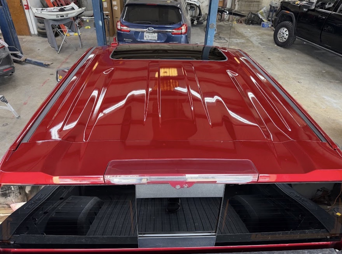 Pickup truck roof after hail damage PDR at DG Collision Center Lewisville TX — original paint intact, all dents removed