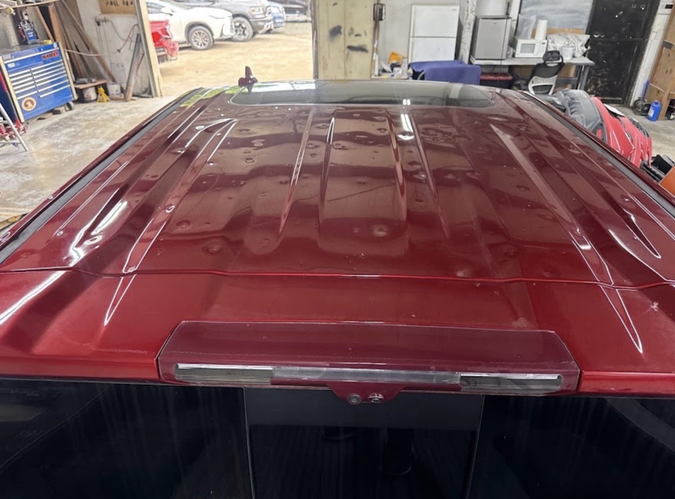 Pickup truck roof before hail damage repair — severe hail dents visible across entire panel at DG Collision Center Lewisville TX