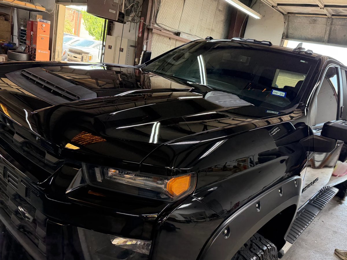 Truck hood after paintless dent repair at DG Collision Center Lewisville TX &mdash; all 120 marked dents removed