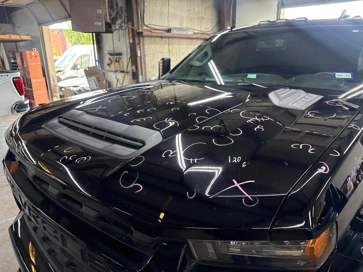 Truck hood with 120 hail dents individually marked in pink before PDR at DG Collision Center Lewisville TX
