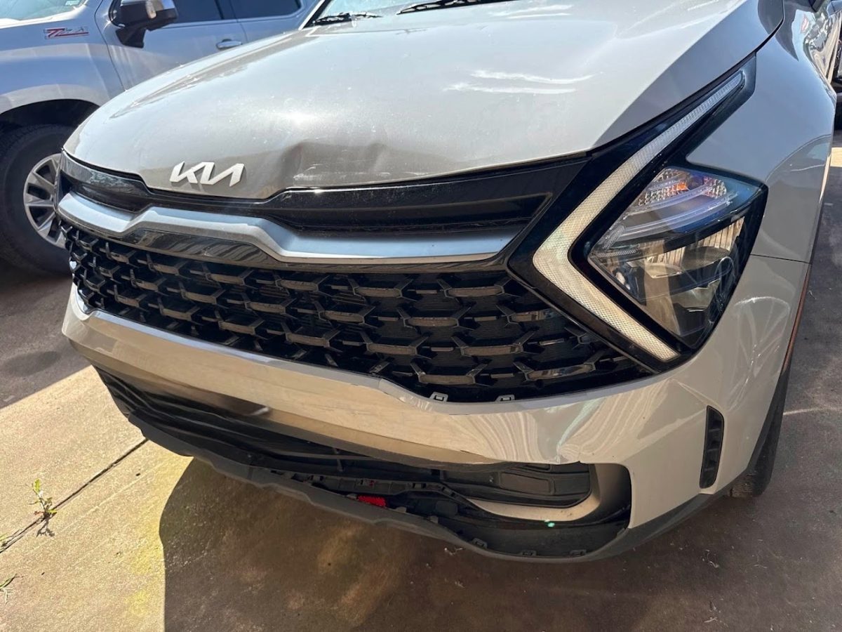 Customer's Kia Sportage with front bumper and hood damage before repair at DG Collision Center in Lewisville, TX