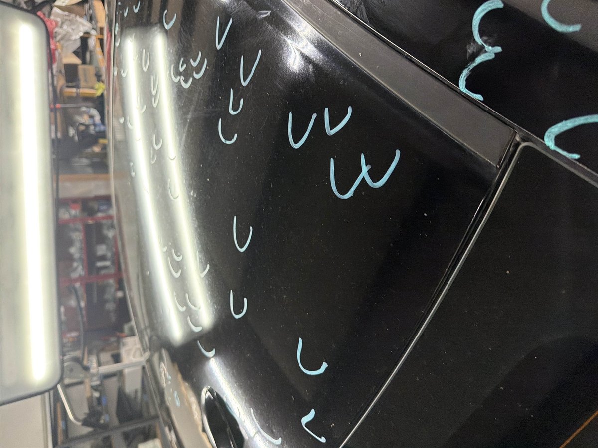 PDR line-board lighting revealing hail dents on a panel at DG Collision Center Lewisville TX