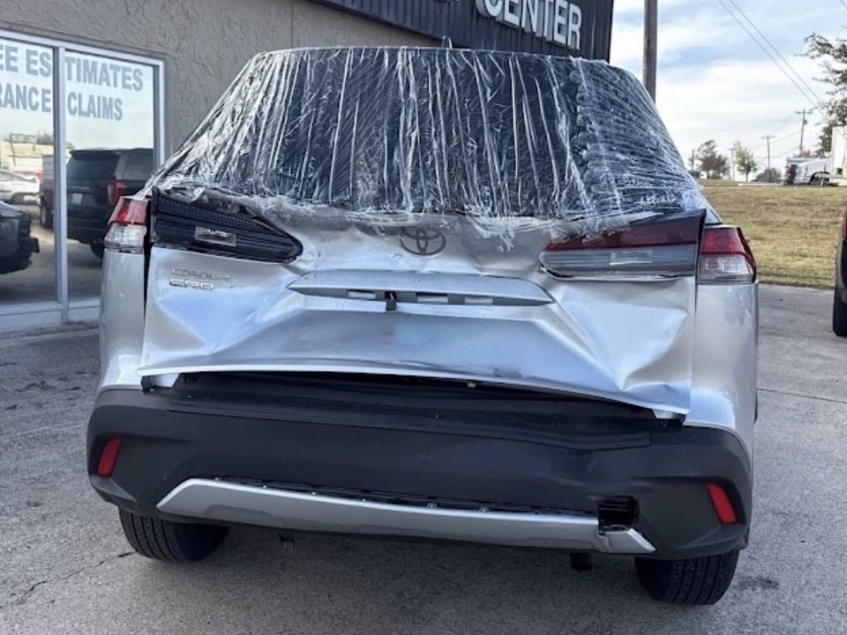 Rear-end collision damage before repair — Toyota Corolla Cross with crushed tailgate and rear panel at DG Collision Center Lewisville TX