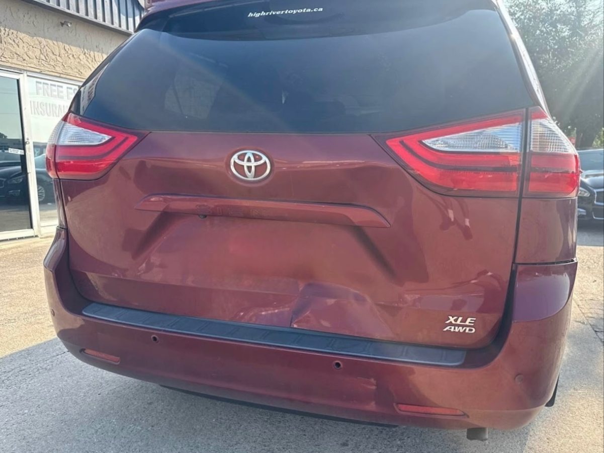 Rear-end collision damage before repair — crumpled trunk and crushed bumper on a The Colony customer vehicle