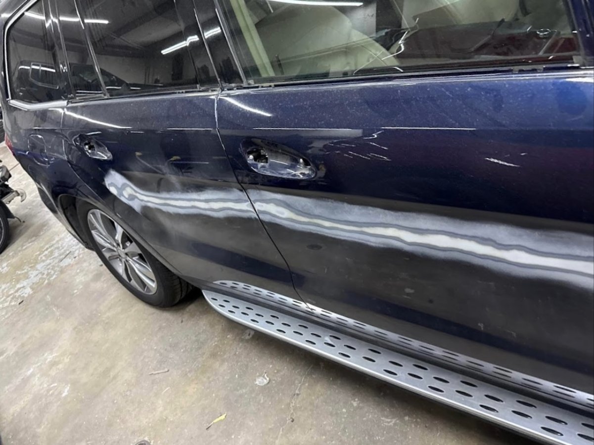 Side-impact damage before repair — crushed driver door on a The Colony customer vehicle
