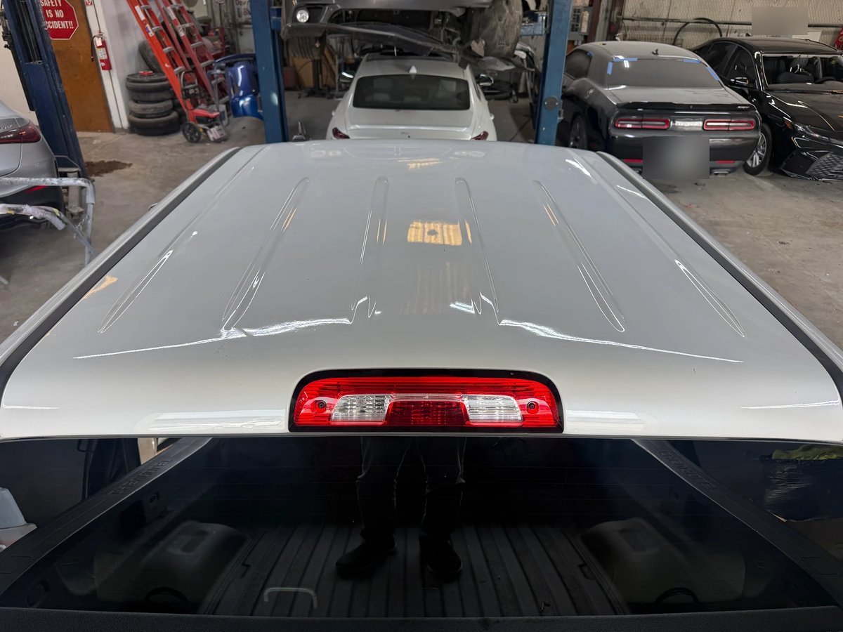 Silverado roof after paintless dent repair at DG Collision Center Lewisville TX &mdash; hail dents gone, factory paint untouched