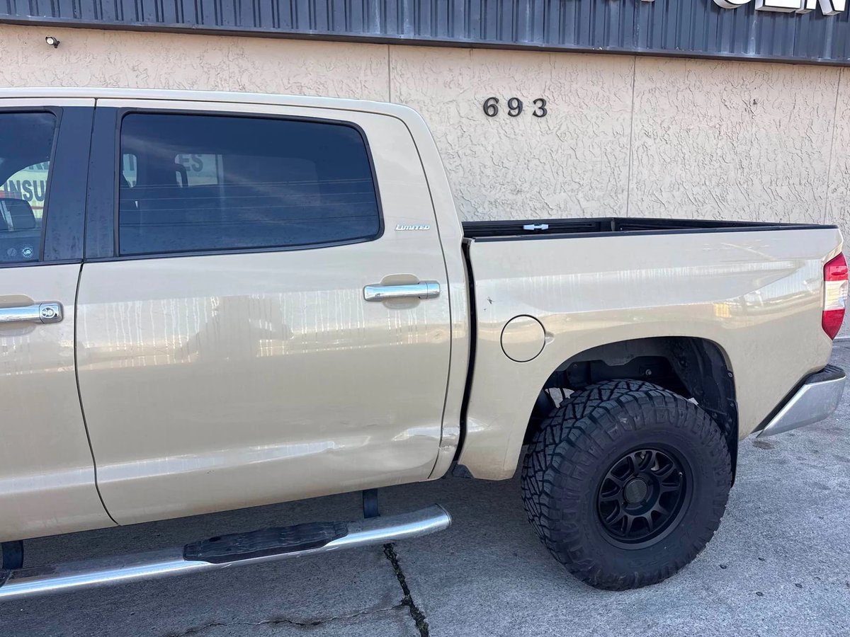 Toyota Tundra with door and bedside dents from a side impact before repair at DG Collision Center Lewisville TX